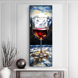 Painting of a glass of wine outdoors against a snow covered mountain landscape displayed above a modern table with vase
