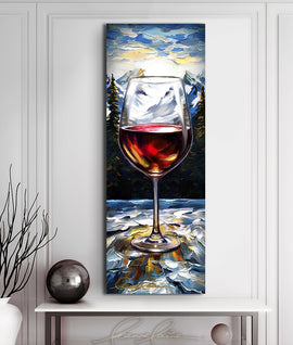 Painting of a glass of wine outdoors against a snow covered mountain landscape displayed above a modern table with vase