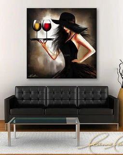 Painting of a woman holding wine glasses above a black sofa in a living room setting.